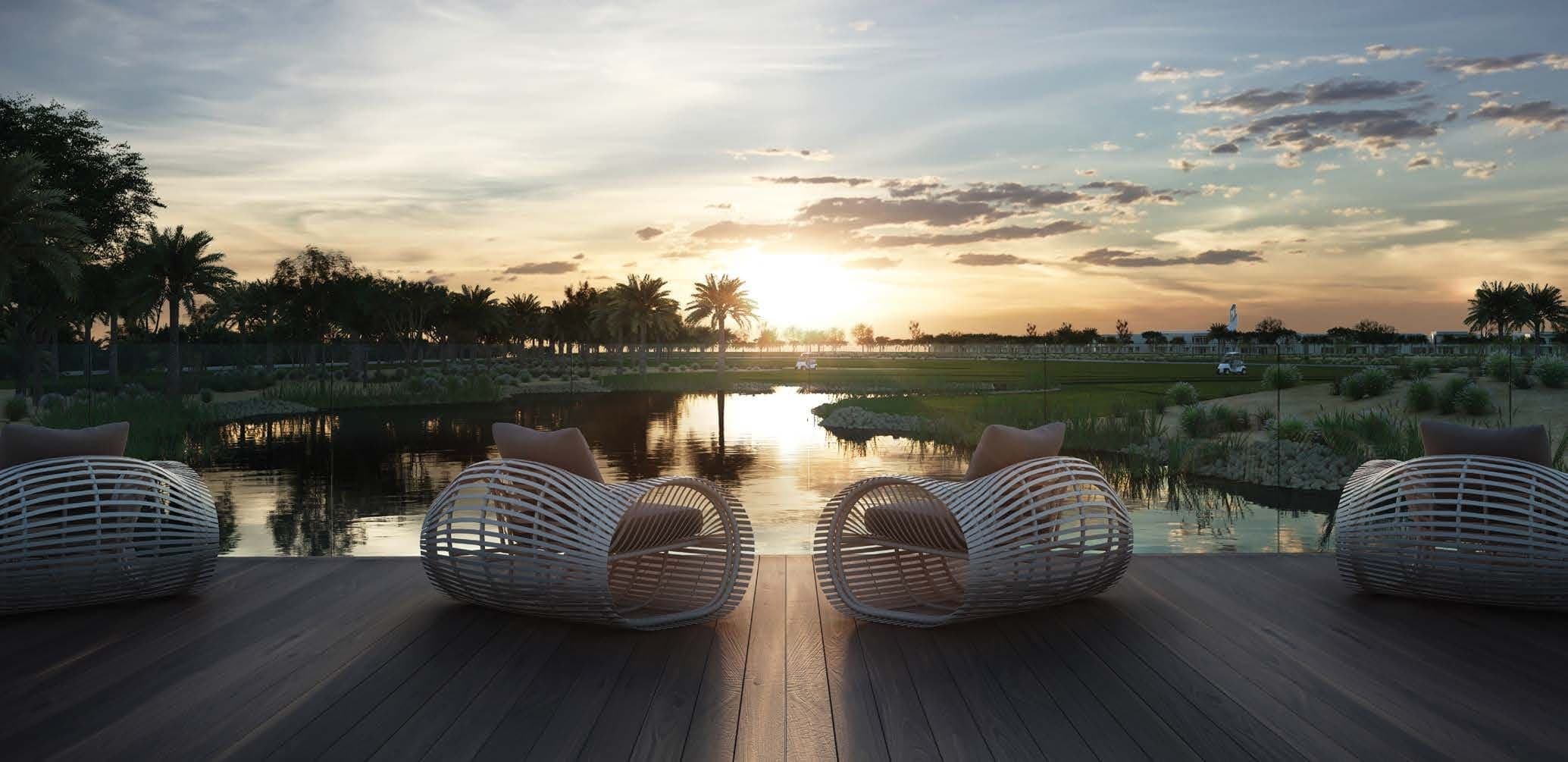 The Orchids at Yas Acres — sunset over the community lake and golf course